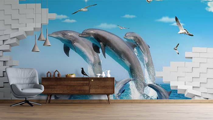 Elegant Dolphins Swimming in Blue Sea Wallpaper shown in a room