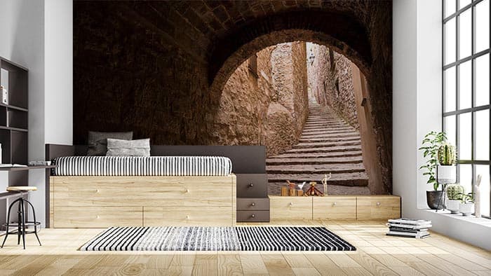 Ancient Stone Passageway Rustic Staircase Wallpaper shown in a room