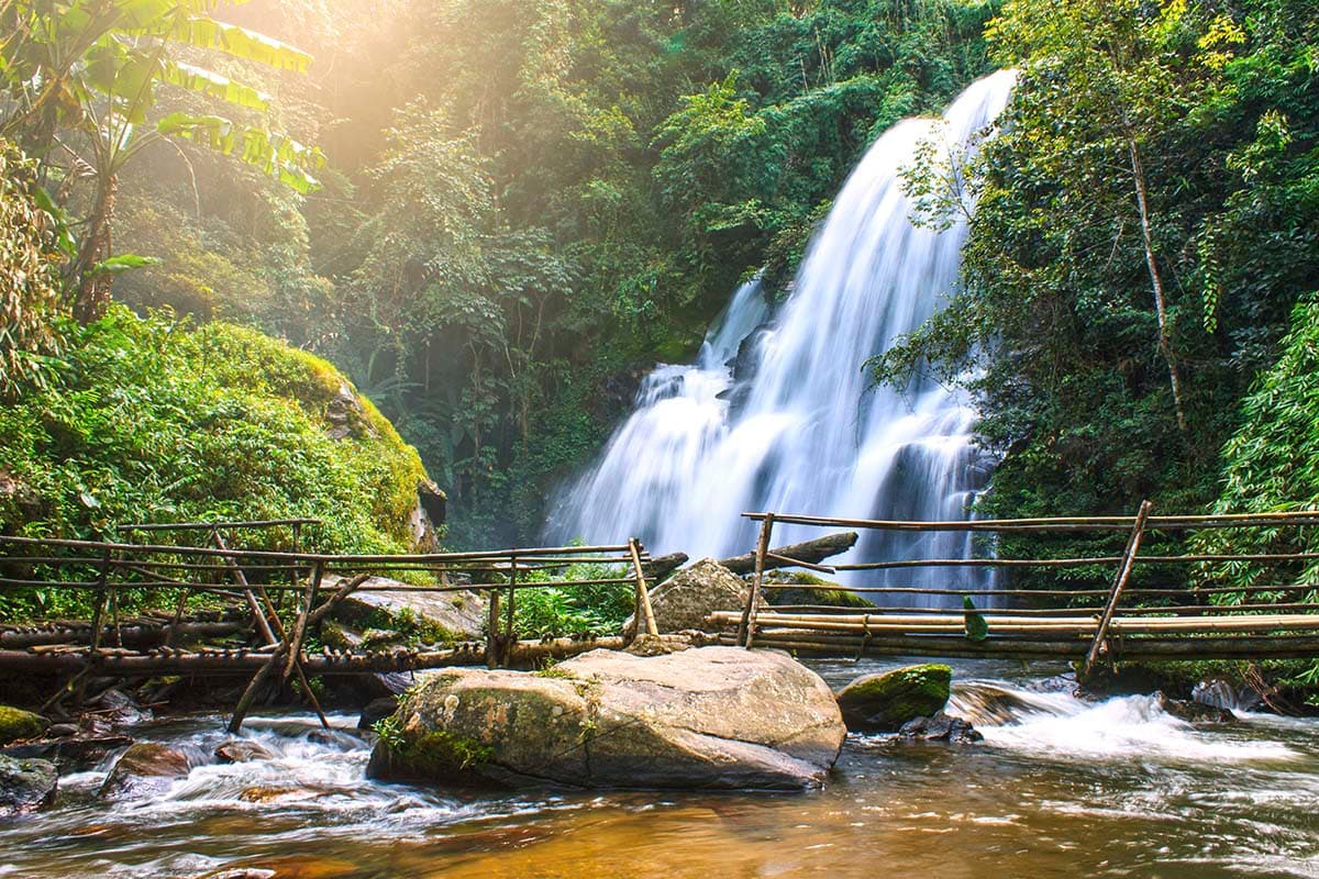 Serene waterfall flowing deep in woods nature wallpaper pattern detail