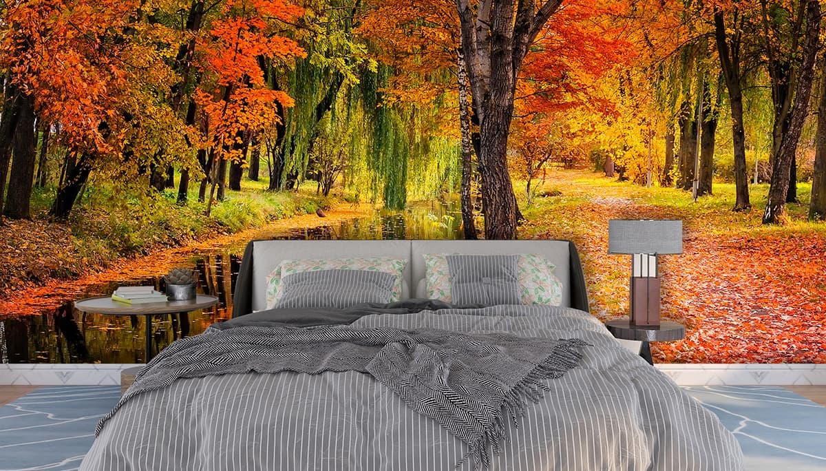 A stream with colorful leaves on the ground shown in a room