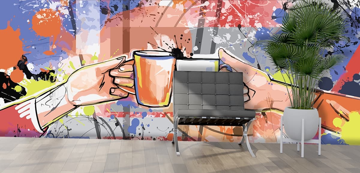 A close up of two hands holding cups shown in a room