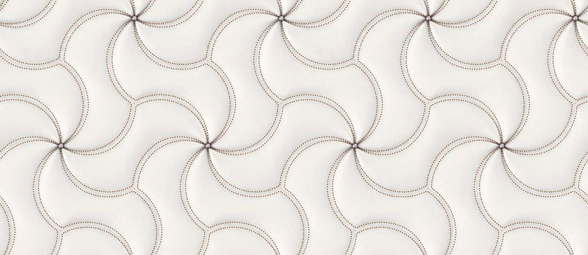 A white leather surface with red stitching pattern detail