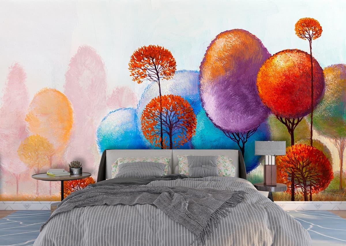 A painting of trees with orange and blue leaves shown in a room