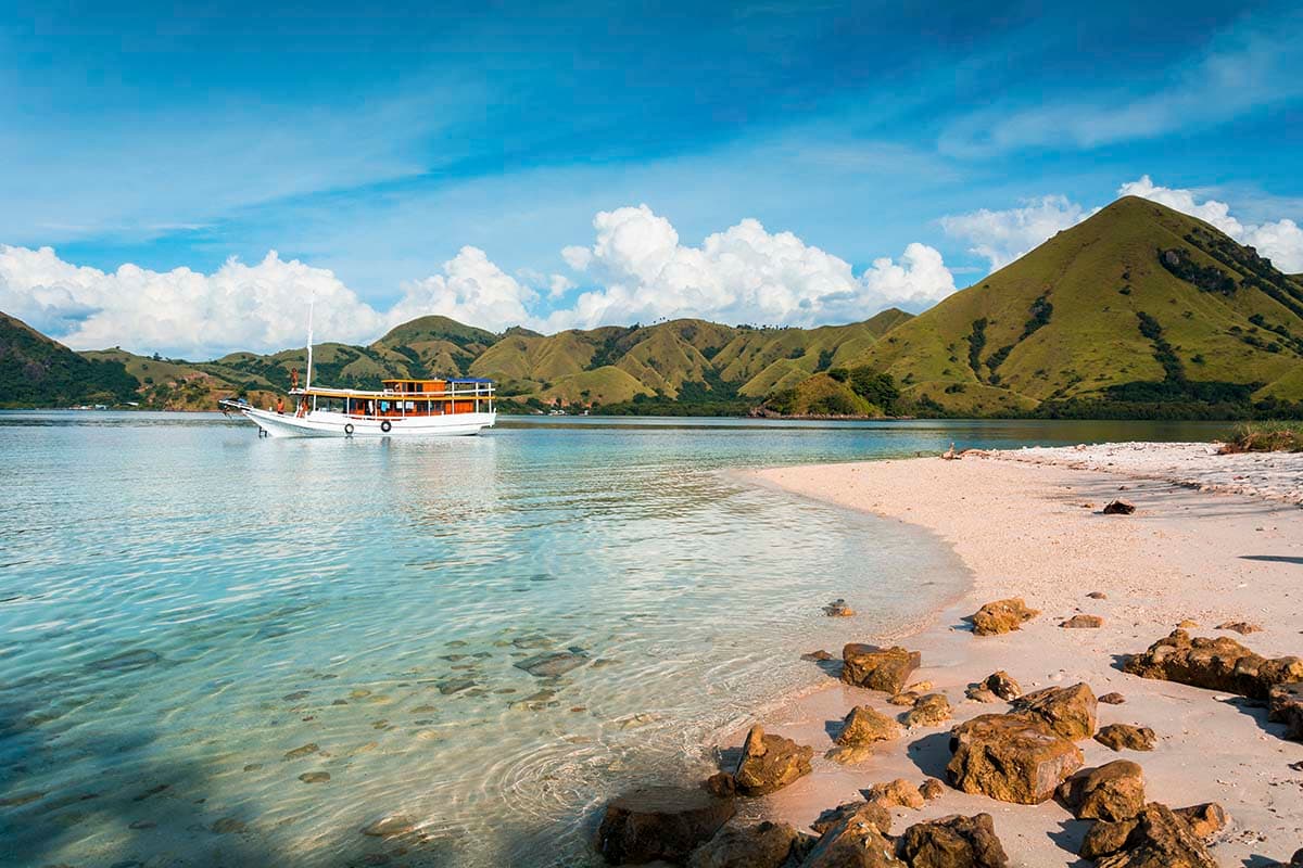 Seaside boat with sandy beach and rolling hills wallpaper pattern detail