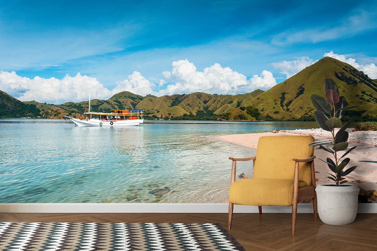 Seaside boat with sandy beach and rolling hills wallpaper shown in a room