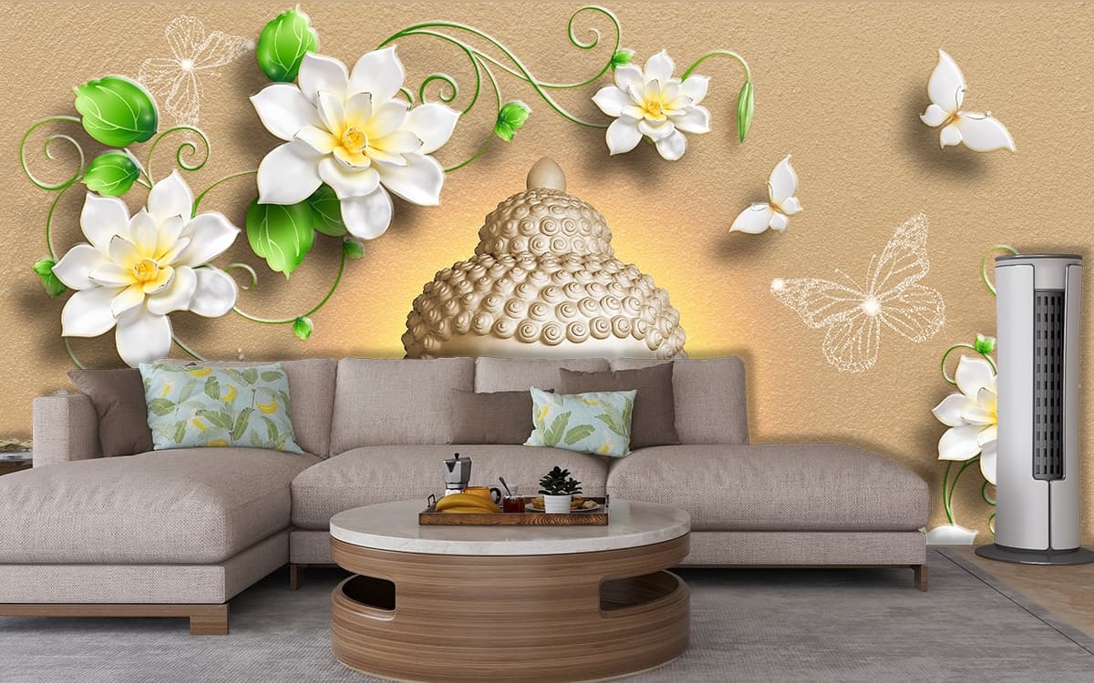 A statue of a buddha with flowers and leaves shown in a room