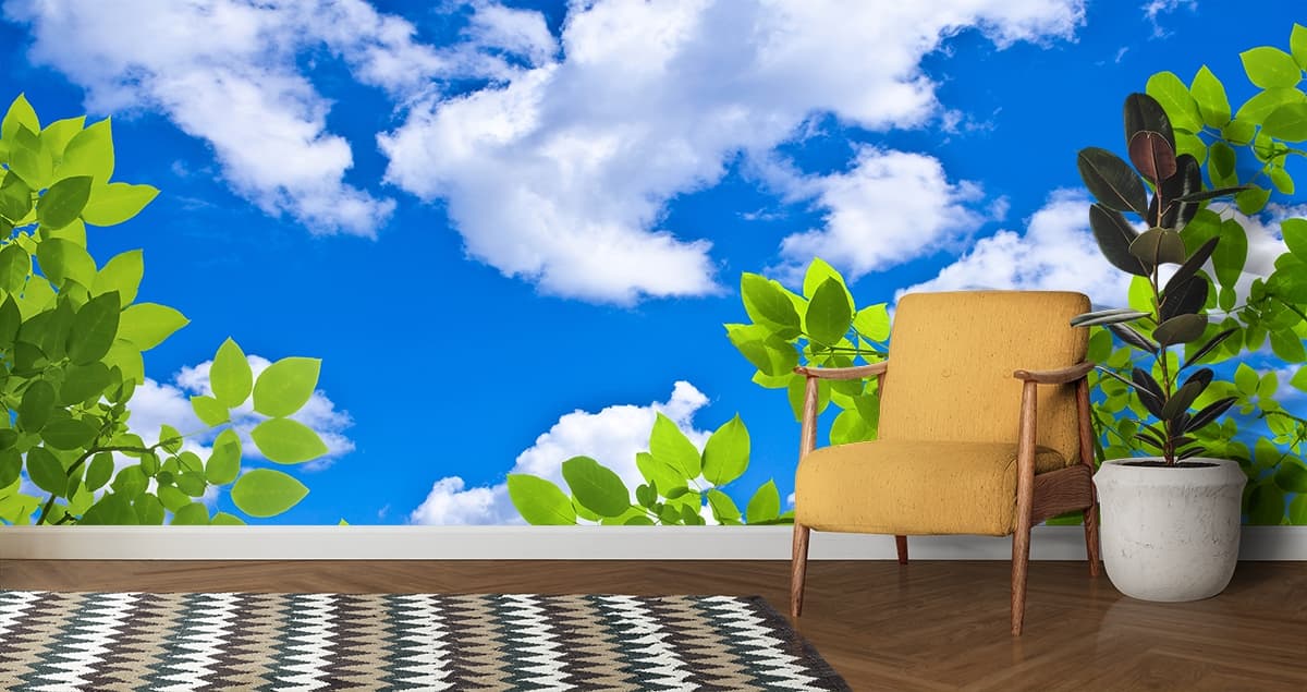 Green Leaves and Blue Sky with Clouds Ceiling Wallpaper shown in a room
