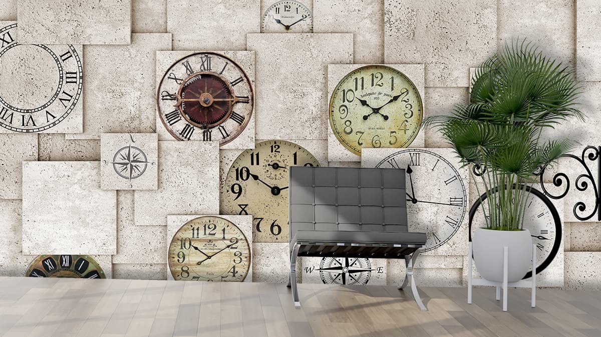 A group of clocks on a wall shown in a room