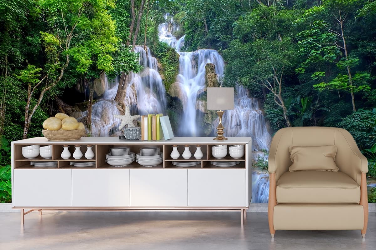 Tranquil waterfall in dense forest landscape wallpaper shown in a room