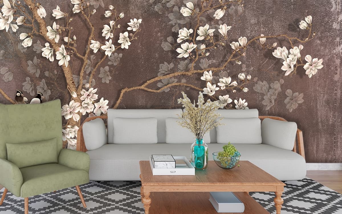 A tree branch with white flowers shown in a room