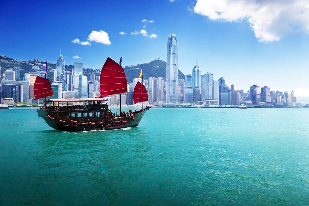 Iconic red sail junk boat in city harbour view wallpaper pattern detail