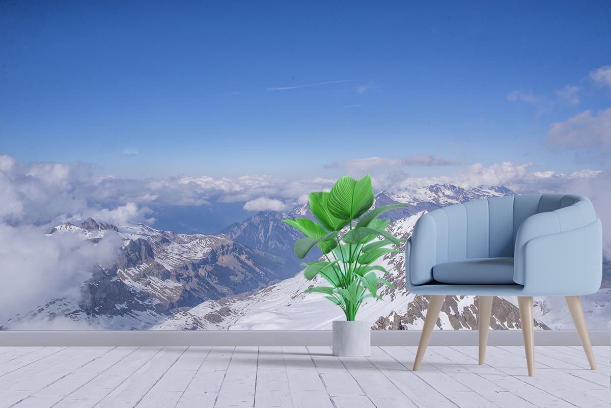 Elegant Snowy Peaks Cloudy Sky Scene Wallpaper shown in a room
