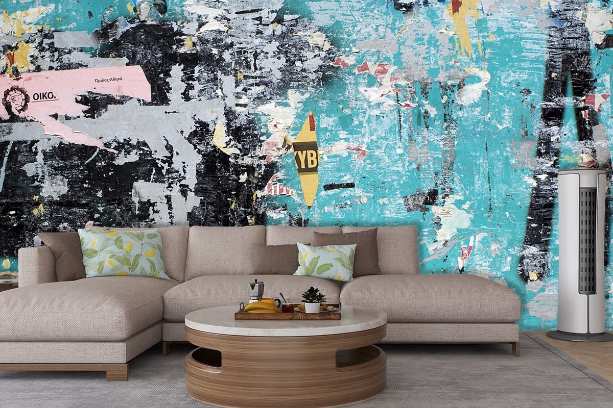 A blue wall with torn posters shown in a room