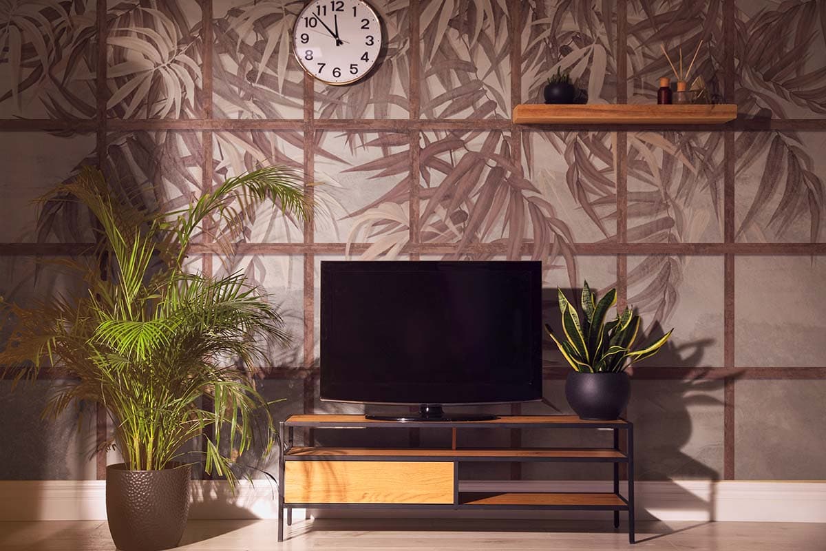Tropical Leaves Among Wooden Shutters Wallpaper shown in a room