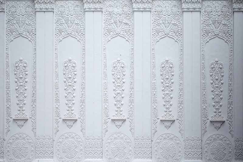 Beautiful Carvings on White Wall Wallpaper pattern detail