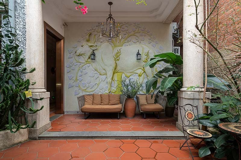 Sacred Cow Stone Carving Wallpaper Mural shown in a room