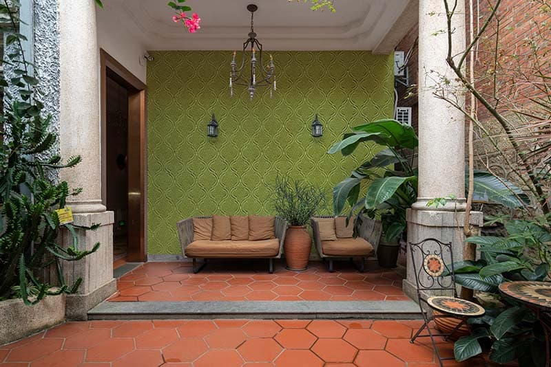 Brocade Texture Olive Green Mural Wallpaper shown in a room