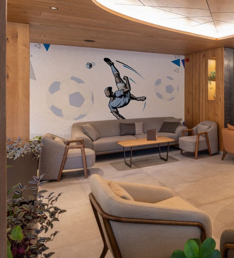 Soccer player Football Wallpaper Wall Mural shown in a room