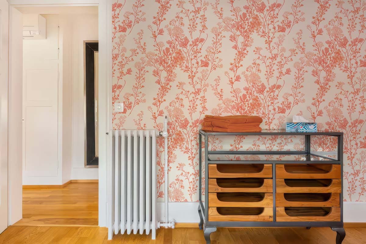 Peach Blossom, Gentle Floral Sprig Wallpaper shown in a room